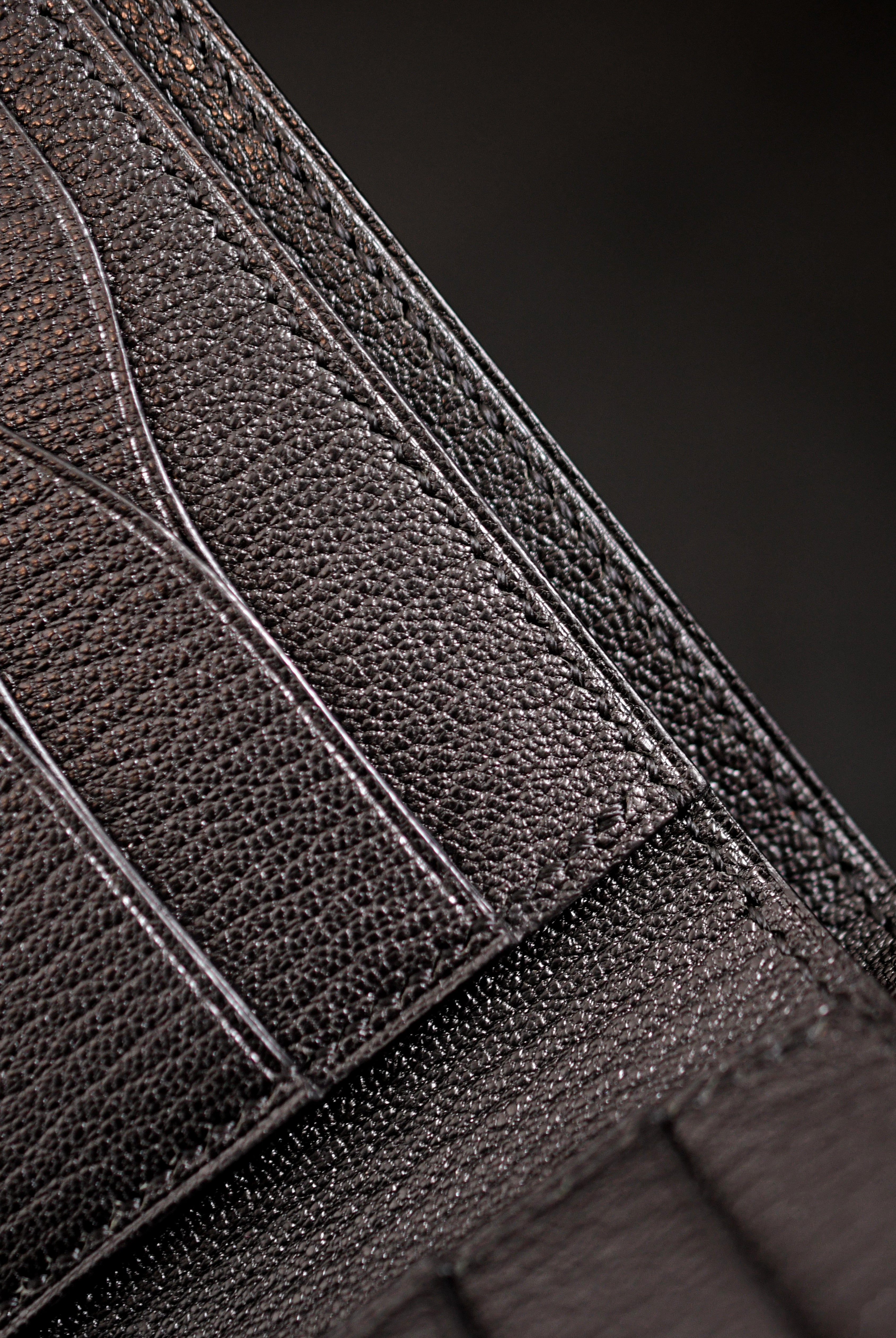 Inside of handmade black goat leather bifold wallet showing curved card pockets, heat-creased and hand-painted edges and saddle stitching — Jackson Boite