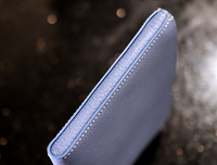 Side view of handmade leather small pouch showing soft leather edge, white saddle stitching and painted edges — Jackson Boite